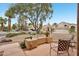 Beautifully landscaped front yard with a seating area and mature trees at 6901 W Tonto Dr, Glendale, AZ 85308