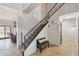 Hallway featuring a staircase, coat rack, and access to additional rooms, offering a functional layout at 6901 W Tonto Dr, Glendale, AZ 85308