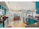 An eat-in kitchen is shown with turquoise cabinets, granite counters, and a view to the pool at 6901 W Tonto Dr, Glendale, AZ 85308