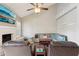 Spacious living room features a fireplace, large sectional sofa, and a ceiling fan at 6901 W Tonto Dr, Glendale, AZ 85308