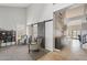 Open-concept living room with high ceilings, sliding barn doors, and neutral decor at 6901 W Tonto Dr, Glendale, AZ 85308