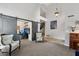 Living room featuring a piano and an adjacent office space with sliding barn doors at 6901 W Tonto Dr, Glendale, AZ 85308