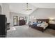 A vaulted-ceiling main bedroom boasts a fireplace, access to the backyard, and an ensuite bathroom at 6901 W Tonto Dr, Glendale, AZ 85308