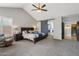 The main bedroom showcases a vaulted ceiling, neutral paint, and a barn door entrance to the bathroom at 6901 W Tonto Dr, Glendale, AZ 85308