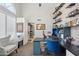 Well-lit home office boasts built-in shelving and a cozy seating area at 6901 W Tonto Dr, Glendale, AZ 85308