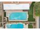 Aerial view of in-ground pool, hot tub, and fenced backyard with green artificial turf at 6901 W Tonto Dr, Glendale, AZ 85308