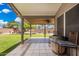 Covered back patio with outdoor furniture, overlooking a spacious grassy yard with a play structure at 7344 E Lindner Cir, Mesa, AZ 85209
