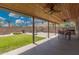 Inviting covered patio with ceiling fan, overlooking the backyard with lush lawn and hardscape at 7344 E Lindner Cir, Mesa, AZ 85209