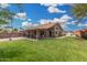 Expansive backyard with lush grass, covered patio, and storage shed, perfect for outdoor activities at 7344 E Lindner Cir, Mesa, AZ 85209