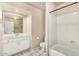 Clean, well-lit bathroom with white tile flooring, shower, and vanity with ample counter space at 7344 E Lindner Cir, Mesa, AZ 85209