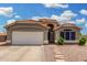 Charming single-story home featuring a well-manicured yard, tile roof, and an attached two-car garage at 7344 E Lindner Cir, Mesa, AZ 85209