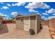 Backyard view of a storage shed, offering space for storing gardening tools and yard equipment at 7344 E Lindner Cir, Mesa, AZ 85209