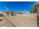 Spacious backyard showing the home's exterior and a large dirt lot at 7345 W Beryl Ave, Peoria, AZ 85345