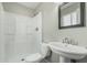This bathroom features a pedestal sink, a toilet and a shower stall at 7345 W Beryl Ave, Peoria, AZ 85345