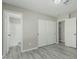 Bedroom features an ensuite bathroom and dual sliding door closet, modern gray wood-look flooring at 7345 W Beryl Ave, Peoria, AZ 85345