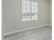 Bedroom with large window overlooking the street, modern gray wood-look flooring at 7345 W Beryl Ave, Peoria, AZ 85345