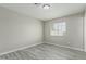 This cozy bedroom features sleek gray wood-look floors and a bright window at 7345 W Beryl Ave, Peoria, AZ 85345
