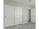Bedroom featuring sliding closet and modern gray wood-look flooring at 7345 W Beryl Ave, Peoria, AZ 85345
