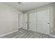 Bedroom with ensuite bathroom, ample closet space, modern gray wood-look flooring at 7345 W Beryl Ave, Peoria, AZ 85345