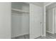 Walk-in closet with a sliding door and hanging rod, modern gray wood-look flooring at 7345 W Beryl Ave, Peoria, AZ 85345
