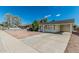 Single-story home with a covered carport and mature landscaping, offering curb appeal at 7345 W Beryl Ave, Peoria, AZ 85345