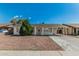 Single-story home with a covered carport and mature landscaping, offering curb appeal at 7345 W Beryl Ave, Peoria, AZ 85345