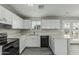 Bright kitchen with white cabinets, quartz countertops, and gray wood-look floors at 7345 W Beryl Ave, Peoria, AZ 85345