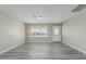 Bright living room features new gray-toned laminate flooring and a large window for natural light at 7345 W Beryl Ave, Peoria, AZ 85345