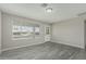 Bright living room features new gray-toned laminate flooring and a large window for natural light at 7345 W Beryl Ave, Peoria, AZ 85345