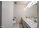 Bathroom featuring dual sinks, a large mirror, and a toilet at 8329 E Keim Dr, Scottsdale, AZ 85250