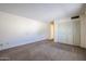 The bedroom features neutral walls, carpet and closet doors, creating a relaxing and inviting space at 8329 E Keim Dr, Scottsdale, AZ 85250