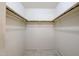 A walk-in closet offers ample storage space with rods and shelves for organizing clothes and accessories at 8329 E Keim Dr, Scottsdale, AZ 85250