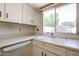 Bright kitchen featuring a window over the sink with white cabinets and countertops at 8329 E Keim Dr, Scottsdale, AZ 85250