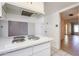 Kitchen featuring electric cooktop, view into additional living areas, and tile flooring at 8329 E Keim Dr, Scottsdale, AZ 85250