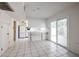Bright eat-in kitchen features white cabinets, tile floor, and sliding glass door to the yard at 8329 E Keim Dr, Scottsdale, AZ 85250
