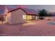 Backyard with gravel, a covered patio, and lush greenery at 9009 E Sahuaro Dr, Scottsdale, AZ 85260