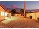 Desert landscaped backyard featuring a covered patio and tall palm trees at 9009 E Sahuaro Dr, Scottsdale, AZ 85260