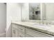 Bright bathroom featuring a double vanity with stone countertops and framed mirror at 9009 E Sahuaro Dr, Scottsdale, AZ 85260