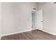Neutral bedroom featuring wood-look flooring and white trim with a walk-in closet at 9009 E Sahuaro Dr, Scottsdale, AZ 85260