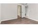 Neutral bedroom with hardwood floors featuring a sliding mirrored closet door at 9009 E Sahuaro Dr, Scottsdale, AZ 85260
