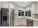Modern kitchen features stainless steel appliances, granite counters, and bay window sink at 9009 E Sahuaro Dr, Scottsdale, AZ 85260