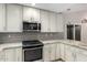Well-lit kitchen features stainless steel appliances, stone countertops, and ample cabinet space at 9009 E Sahuaro Dr, Scottsdale, AZ 85260
