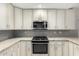 Well-lit kitchen features stainless steel appliances, stone countertops, and ample cabinet space at 9009 E Sahuaro Dr, Scottsdale, AZ 85260
