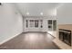 Bright living area features large windows, a sliding glass door, and cozy fireplace at 9009 E Sahuaro Dr, Scottsdale, AZ 85260