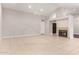 Large open living room features high ceilings, tile flooring, and cozy fireplace at 9009 E Sahuaro Dr, Scottsdale, AZ 85260