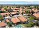 An aerial view of a desert home with a private pool and a red tile roof, surrounded by lush landscaping at 10510 E Terra Dr, Scottsdale, AZ 85258