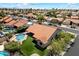 Aerial view of a home with a backyard pool, desert landscaping, and tile roof in a residential neighborhood at 10510 E Terra Dr, Scottsdale, AZ 85258
