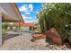 Backyard with pool, covered patio and brick pavers with additional seating area under flowering tree at 10510 E Terra Dr, Scottsdale, AZ 85258