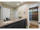 Bathroom with double sinks, granite countertops, and a view of the bathtub and shower at 10510 E Terra Dr, Scottsdale, AZ 85258