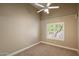 Bedroom with neutral walls and carpet, a ceiling fan, and a window with plantation shutters at 10510 E Terra Dr, Scottsdale, AZ 85258